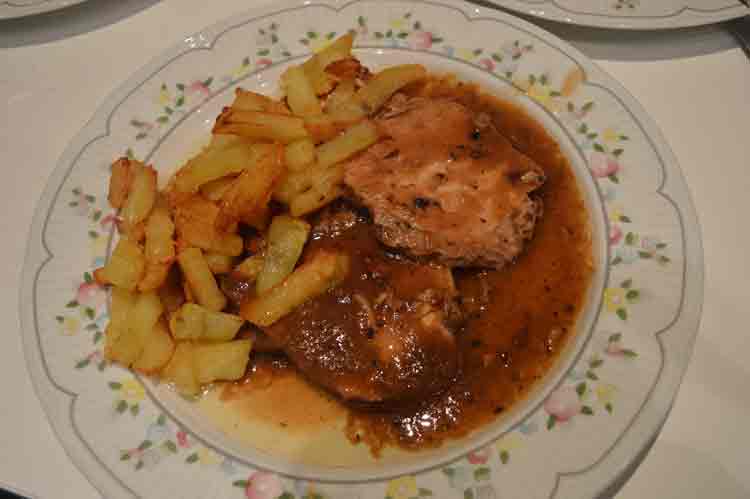 Redondo de lomo de cerdo en salsa de cebolla con patatas fritas