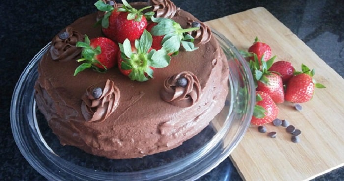 tarta de chocolate con trufa decorada con fresas y pepitas de chocolate